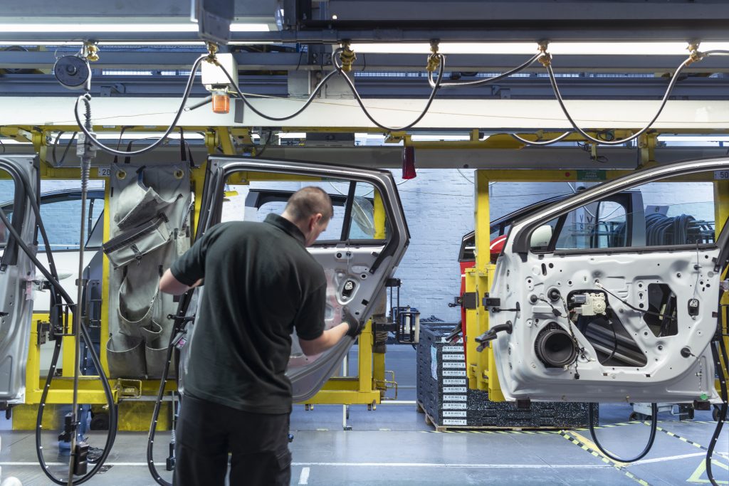 Worker on Car Door Assembly Line In Car Factory